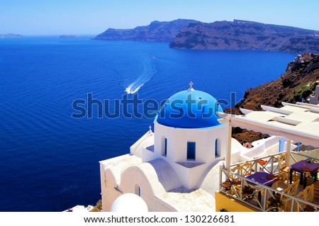 Blue dome church with boat, Oia village, Greece