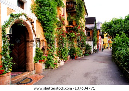 Flower Lined Street In The Traditional Austrian Village Of Hallstatt