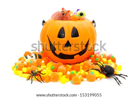 Halloween Jack o Lantern pail with pile of candy over white Halloween Jack o Lantern pail with pile of candy over white