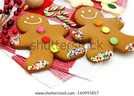 Gingerbread Men and candy canes on checked cloth