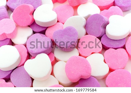 Valentines Day background of pink, purple and white candy hearts