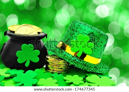 St Patricks Day Pot of Gold, hat and shamrocks over a green background