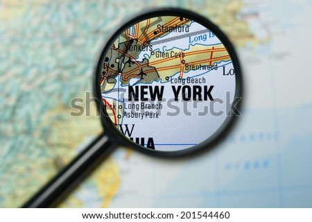 Close up of New York City under a magnifying glass on a map