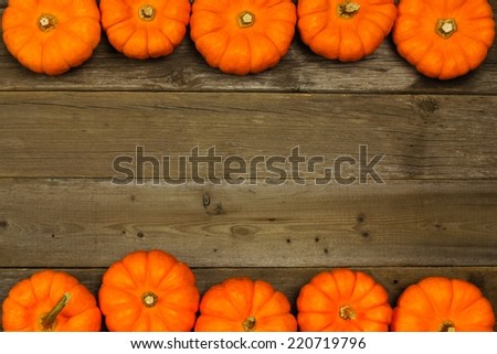 Double edge autumn pumpkin border against aged wood