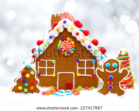 Christmas gingerbread house with twinkling silver light background