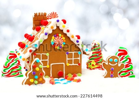 Christmas gingerbread house scene with twinkling silver light background