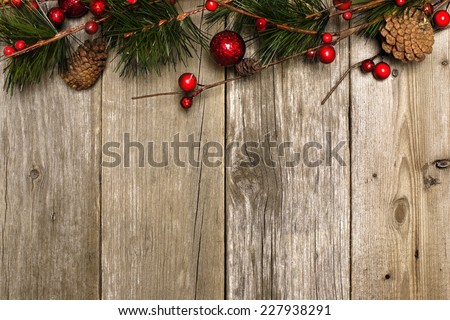 Aged wood Christmas background with branches and baubles top border