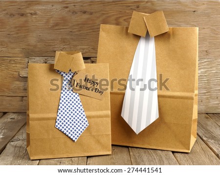 Fathers Day handmade shirt and tie gift bags with greeting card on a wood background
