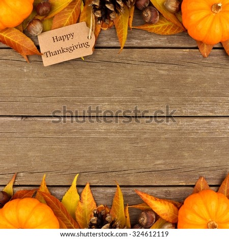 Happy Thanksgiving gift tag with double border of colorful leaves and pumpkins over a rustic wood background