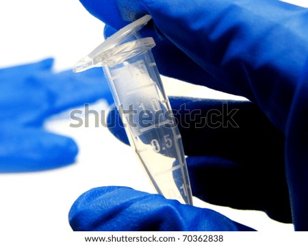 Laboratory scene - a hand holding a small test tube