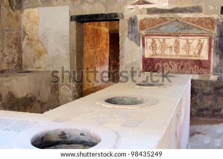 Ancient Pompeii - Thermopolium of Asellina with old food serving counter and fresco
