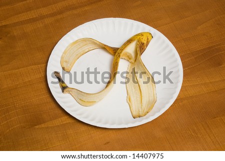 a partially eaten banana on a paper plate