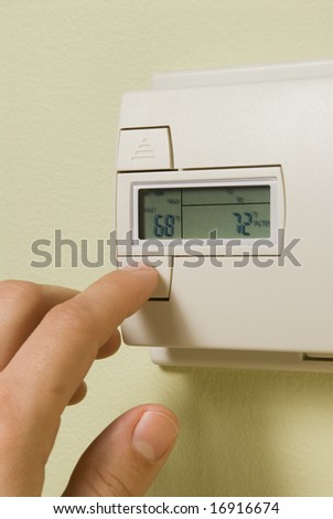 adjusting a home thermostat to save energy