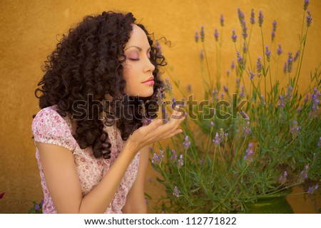 Portrait of beautiful young lady with lavender flowers