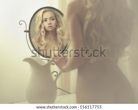 Nude Elegant Blonde Woman In Front Of The Mirror