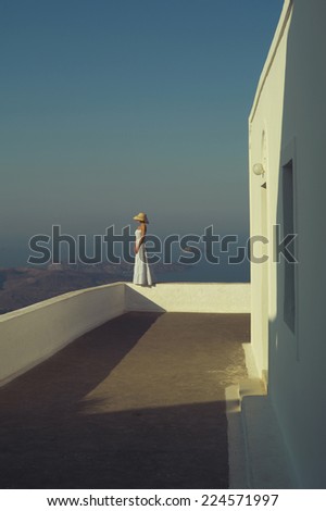 Fashion photo of a romantic lady looking at the sea