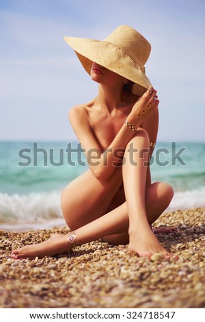 Elegant naked lady at the sea. Summer travel photos