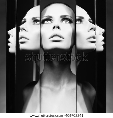 Fashion studio portrait of woman and mirrors on black background