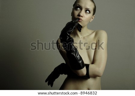 nude elegant girl with the gloves. Studio fashion photo.