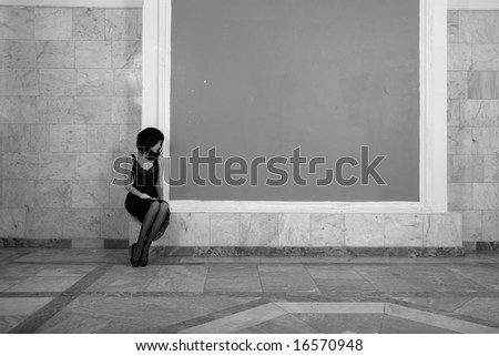 Fashion portrait of young attractive lady in palace. Black and white photo