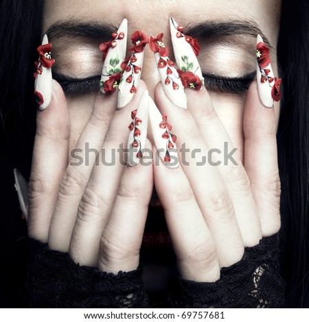 Portrait of a beautiful young woman with long designer nails