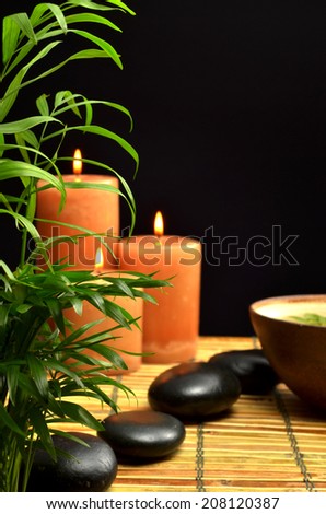house plant candle smooth stones bowl on place mat