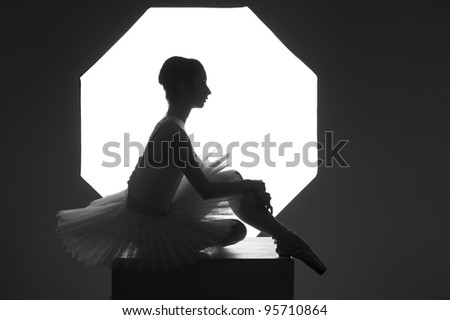 Ballerina sitting on a cube