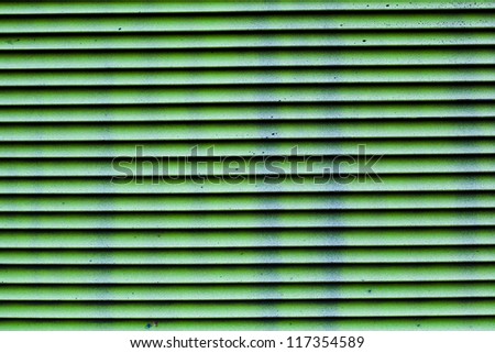 Abstract horizontal stripes of green. Ventilation grille close-up.