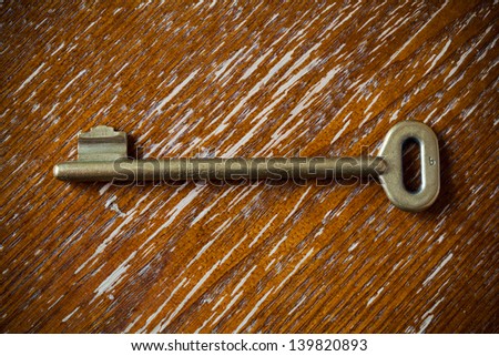 Antique key. Vintage board.