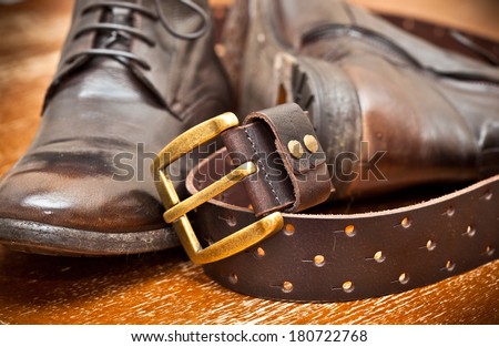 men\'s shoes and leather belt brown with gold buckle. cowboy style