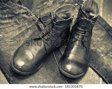 Fashionable leather shoes, leather belt, jeans. Cowboy style. Vintage style. Black and white photo
