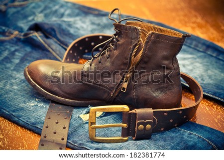 leather shoes, leather belt with a gold buckle, jeans. Cowboy style. Vintage style