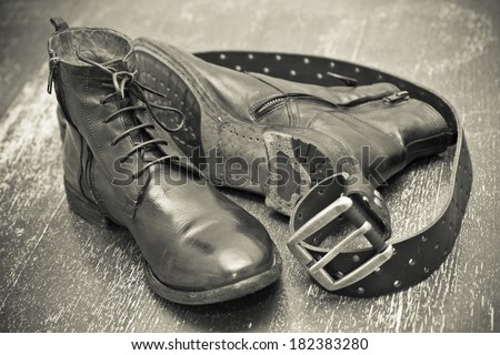 luxury leather shoes and a leather belt with buckle. cowboy style. vintage style