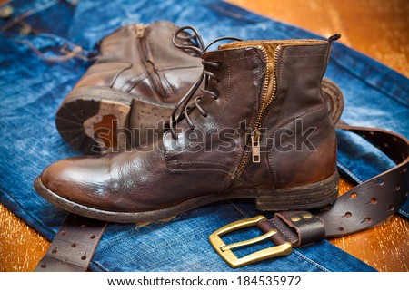 leather shoes, leather belt with a gold buckle, jeans. Cowboy style. Vintage.