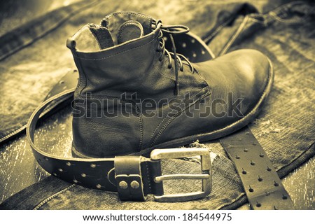 Fashionable leather shoes, leather belt and jeans. cowboy style, vintage.