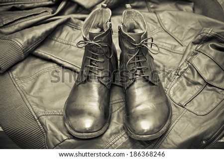 fashionable leather boots and leather jacket. handmade shoes. black and white photo