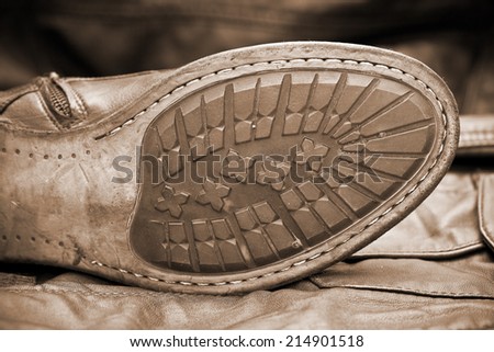 Male shoe sole. Handmade shoes. Vintage style. Cowboy style. Autumn and spring shoes. Photo toning in sepia