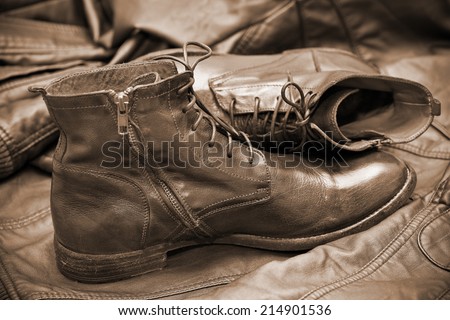 fashionable leather boots and leather jacket. handmade shoes. Autumn and spring shoes. Photo toning in sepia