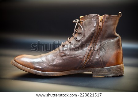 Fashionable men\'s leather shoes on a dark abstract background. Autumn - spring shoes. brown boots closeup