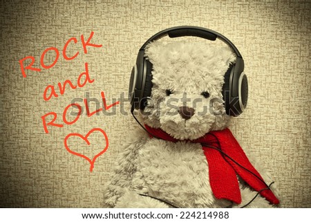 Teddy bear with headphones. Lover of music and rock and roll. Photo tinted in yellow