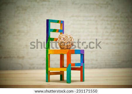 multicolored toy chair and wicker ball handmade