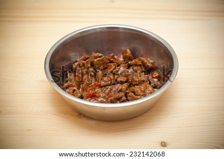 bowl with meat and vegetables for the animal. Food for dogs and cats
