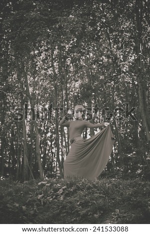 Beautiful retro girl in a dress in the forest. Vintage style