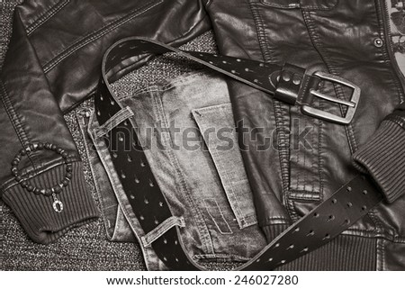 Fashion trend, parts of clothing: Leather jacket, jeans with a belt and bracelet. retro Style