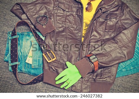 Fashion concept: a jacket, jeans, belt, shirt, watch, bracelet, sunglasses, 5 Euro. Youth urban clothing. Vintage style