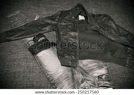 fashion clothing for brutal men: leather jacket, jeans, a leather belt with a buckle