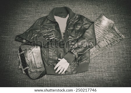 clothing for brutal men: leather jacket, jeans, a leather belt with a buckle, wristwatch