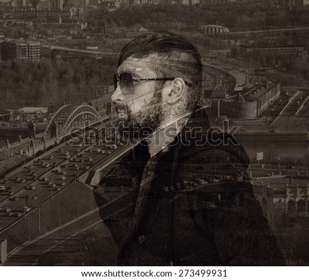 Brutal man with a beard and sunglasses on city background. Photo collage, effect of multiple exposure
