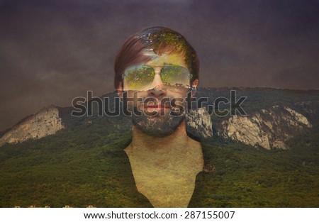 Double exposure the man\'s face and a landscape of forests, mountains and sky