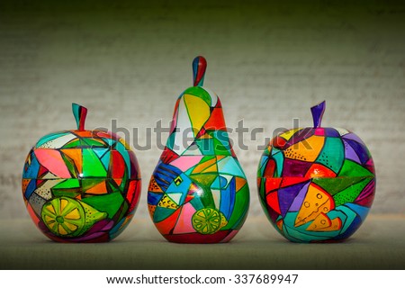 work of modern art - decorative apples and pear on a green background